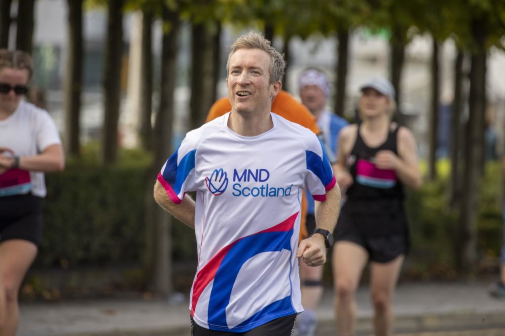 Man running with MND Scotland tshirt on